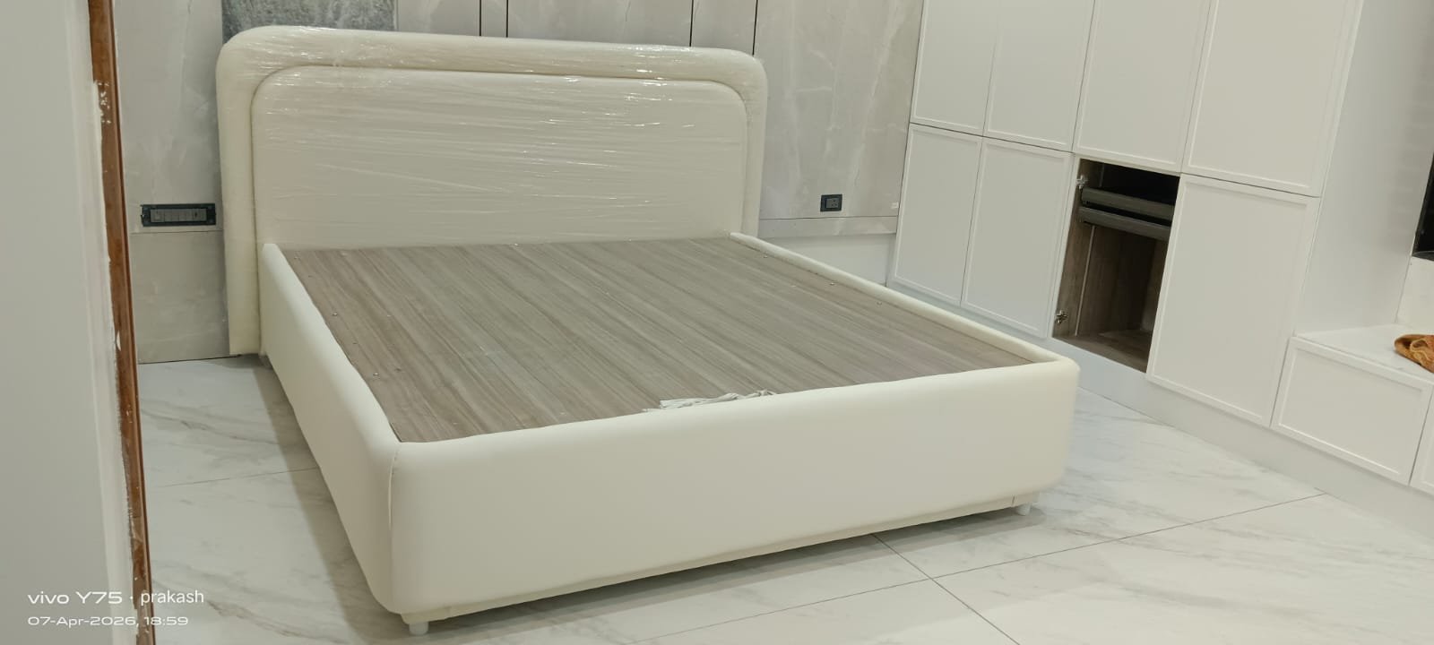 Upholstered bed with beige leather headboard
